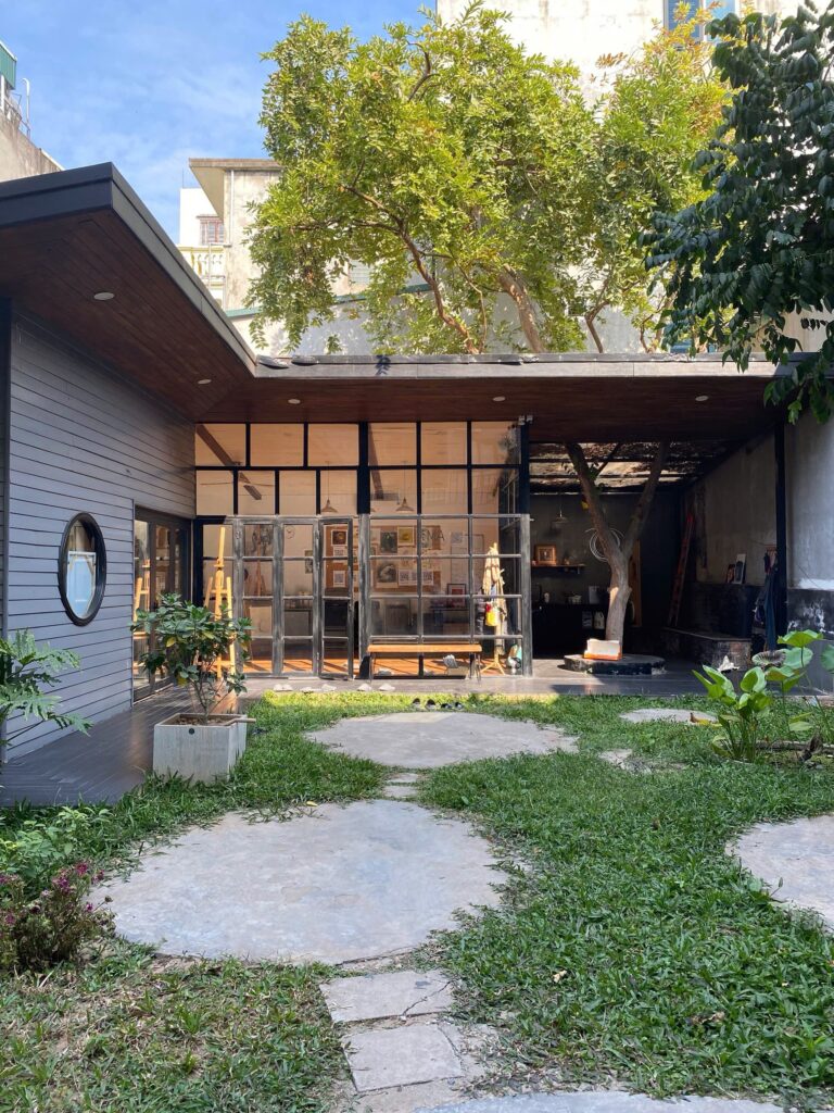 art studio for creative experiences in Hanoi that is surrounded by green garden that has a path